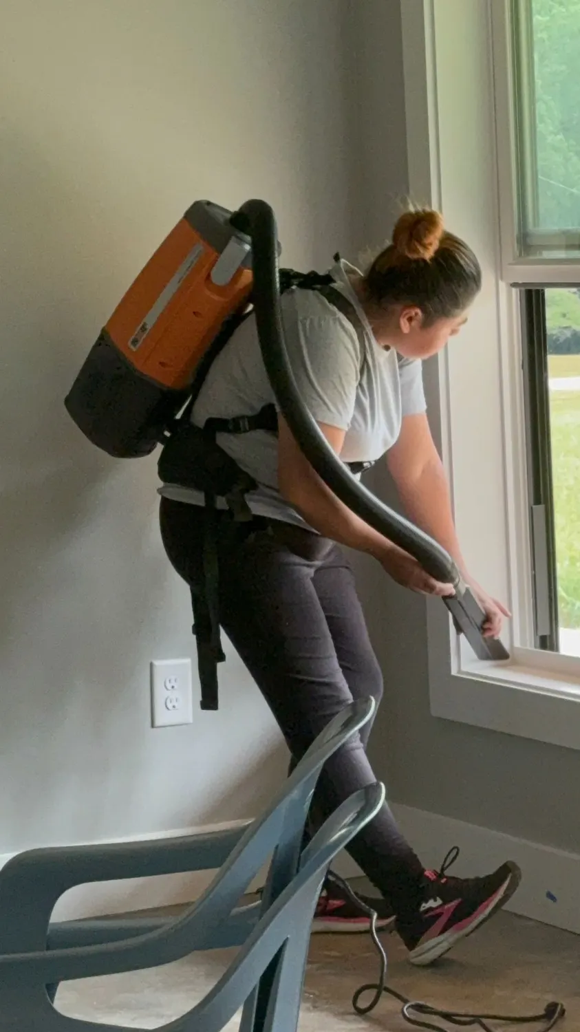 Cleaning technician with backpack vacuum